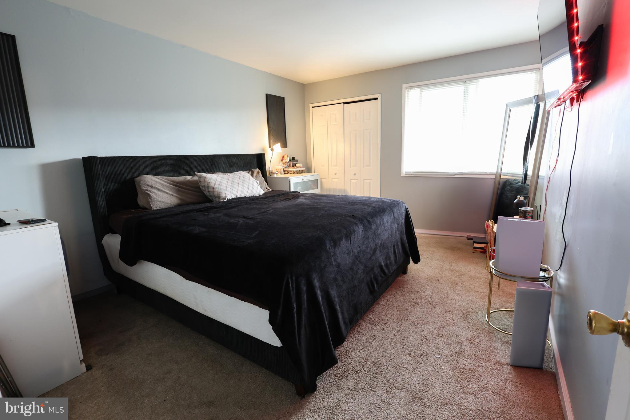 7232 Donnell Place, Unit D District Heights, MD 20747 - Photo 18 of 23 a large bed sitting in a bedroom next to a window