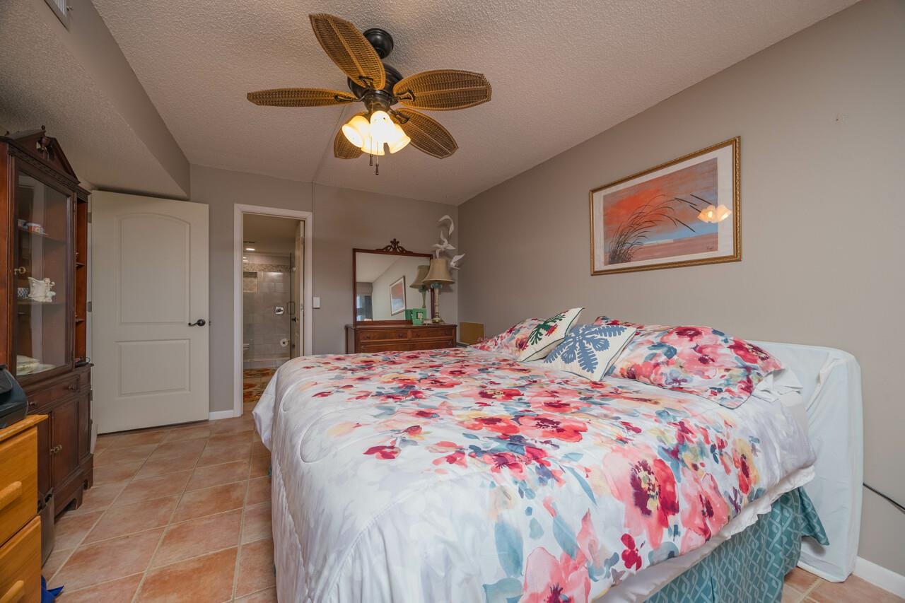 2 Dondanville Road, Unit 304 St. Augustine, FL 32080 - Photo 12 of 43 a bedroom with a large bed and a chandelier
