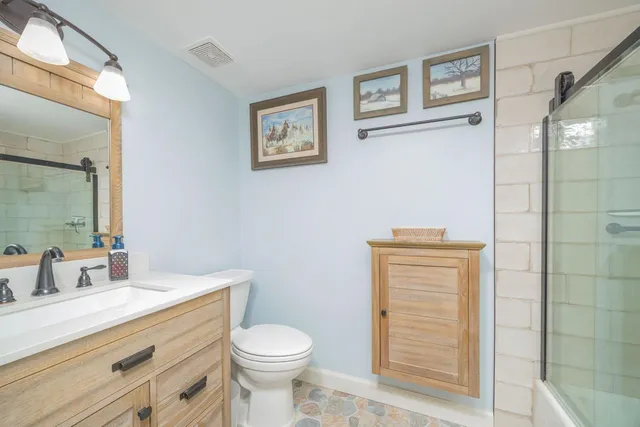 a view of a hallway with wooden floor and stairs