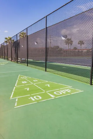 a view of balcony with a large window and wooden fence