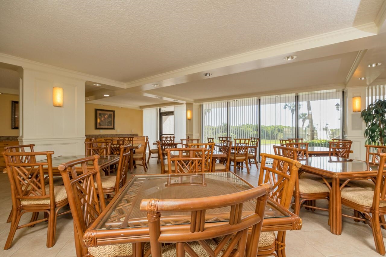 2 Dondanville Road, Unit 304 St. Augustine, FL 32080 - Photo 41 of 43 a dining room with furniture a chandelier and large windows