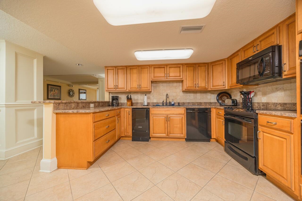 2 Dondanville Road, Unit 304 St. Augustine, FL 32080 - Photo 43 of 43 a kitchen with stainless steel appliances granite countertop a stove sink and cabinets