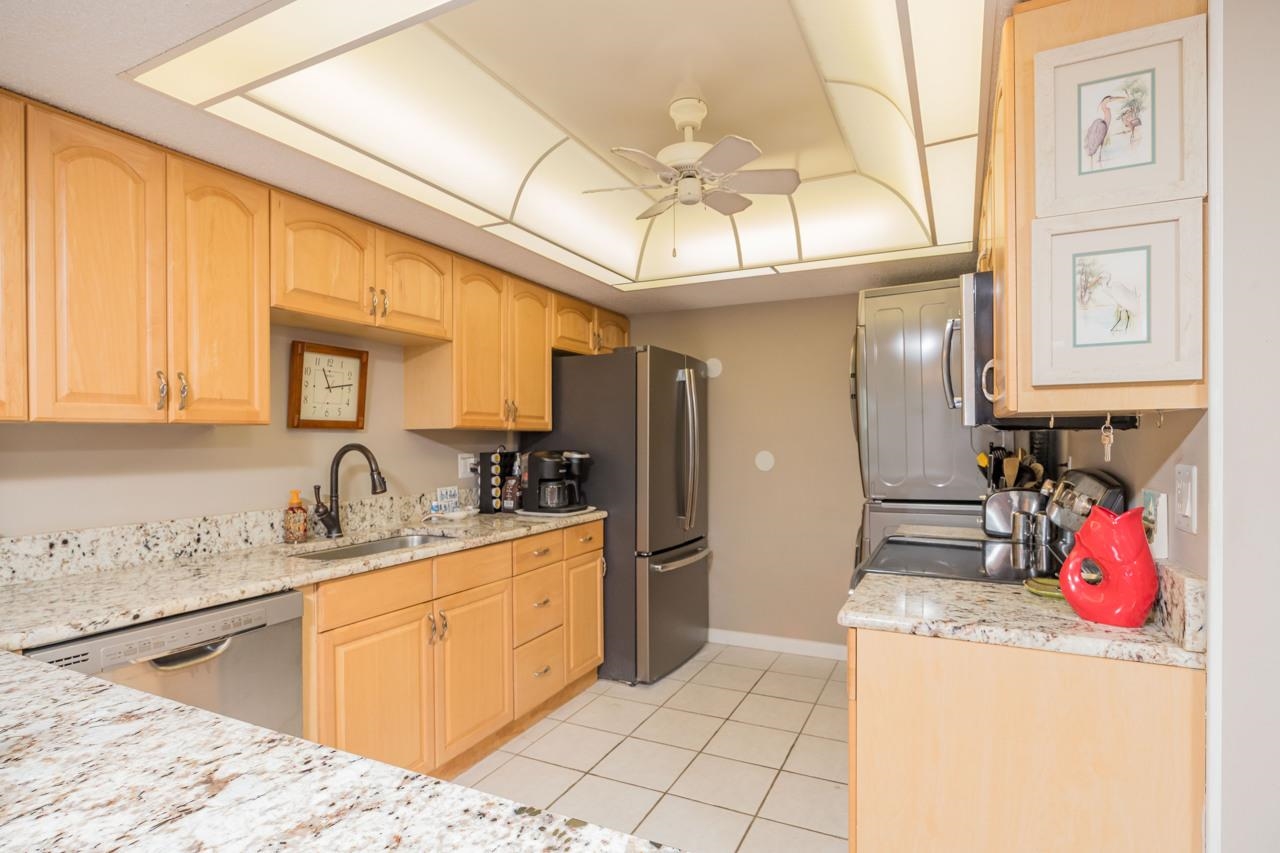 2 Dondanville Road, Unit 304 St. Augustine, FL 32080 - Photo 9 of 43 a kitchen with stainless steel appliances granite countertop a sink and cabinets