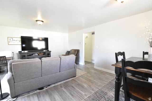 290 West 600 North Logan, UT 84321 - Photo 10 of 45 Open-concept living space featuring wood-finish flooring, recessed lighting, and crisp white walls