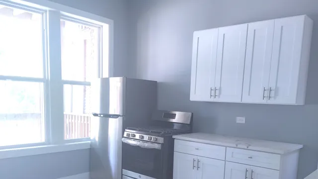 a kitchen with appliances cabinets and a window