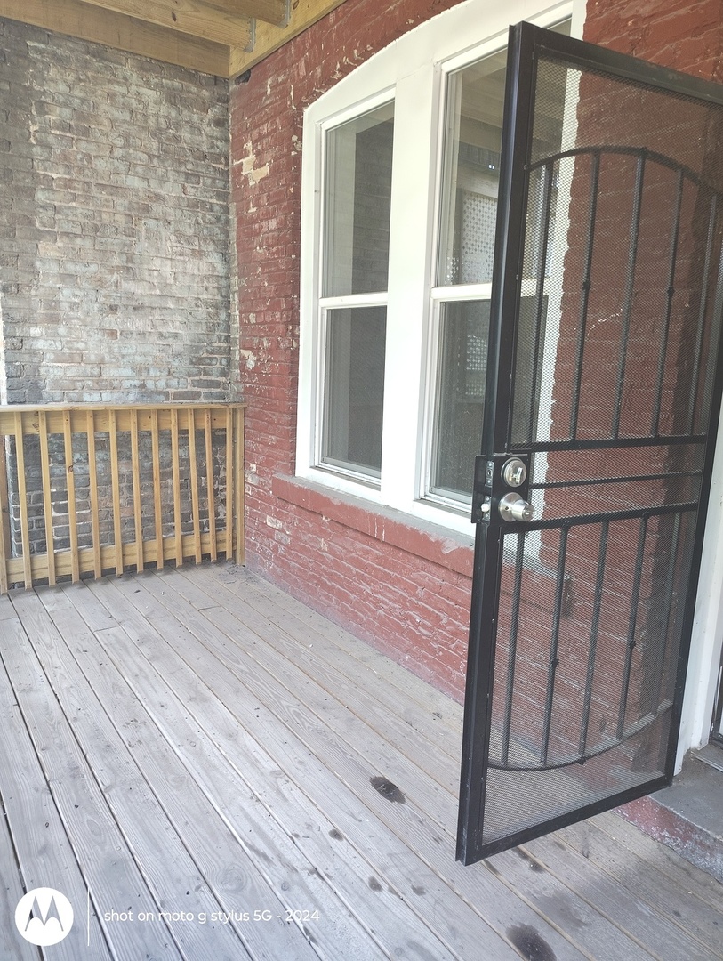 1661 South Homan Avenue, Unit 1 Chicago, IL 60623 - Photo 9 of 11 a view of wooden balcony