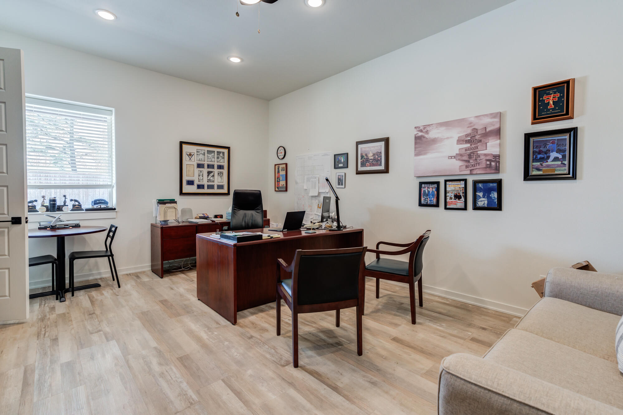 3405 107th Street Lubbock, TX 79423 - Photo 26 of 41 a living room with furniture a desk and chair with wooden floor