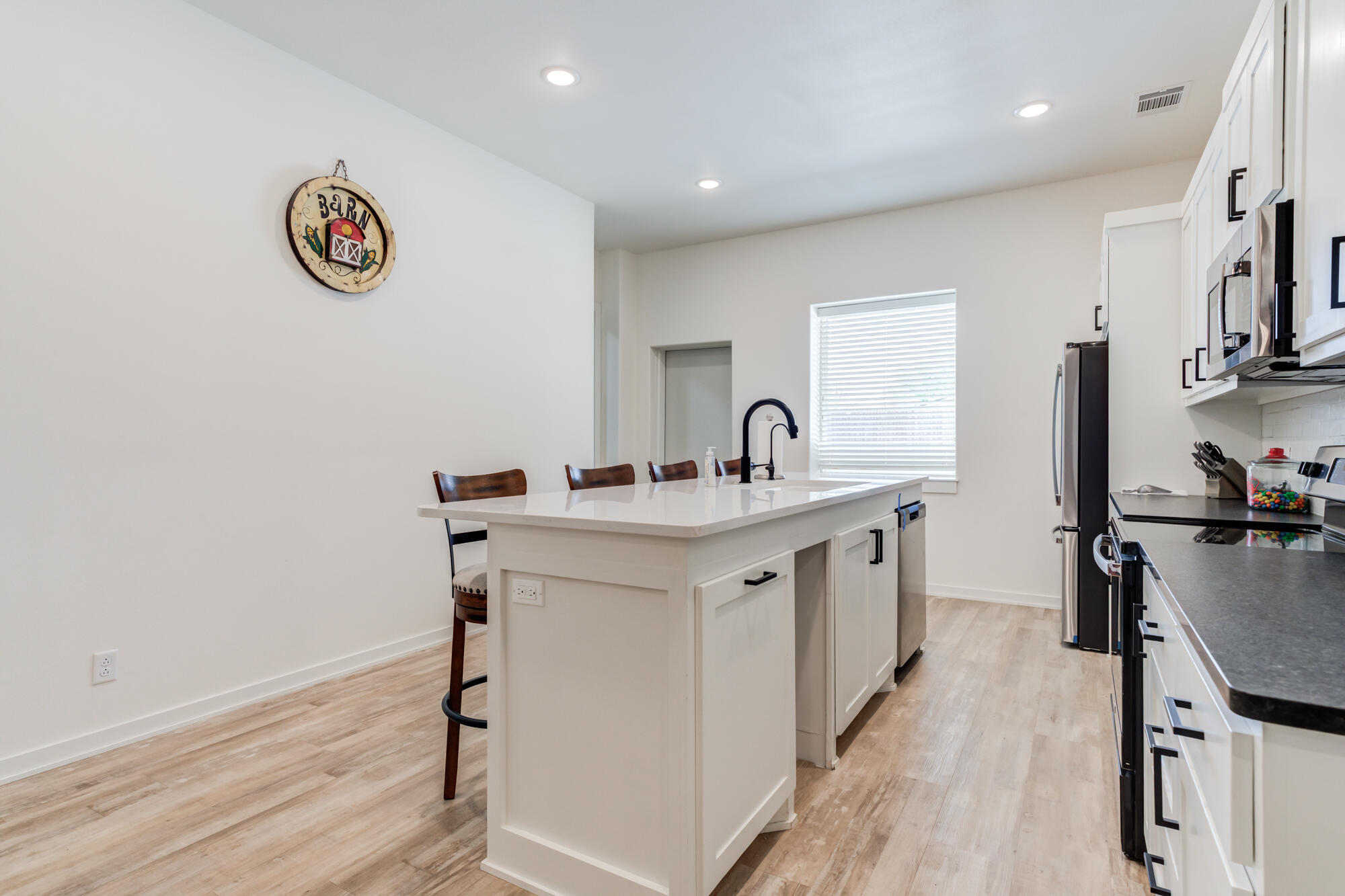 3405 107th Street Lubbock, TX 79423 - Photo 33 of 41 a kitchen with a sink cabinets and wooden floor