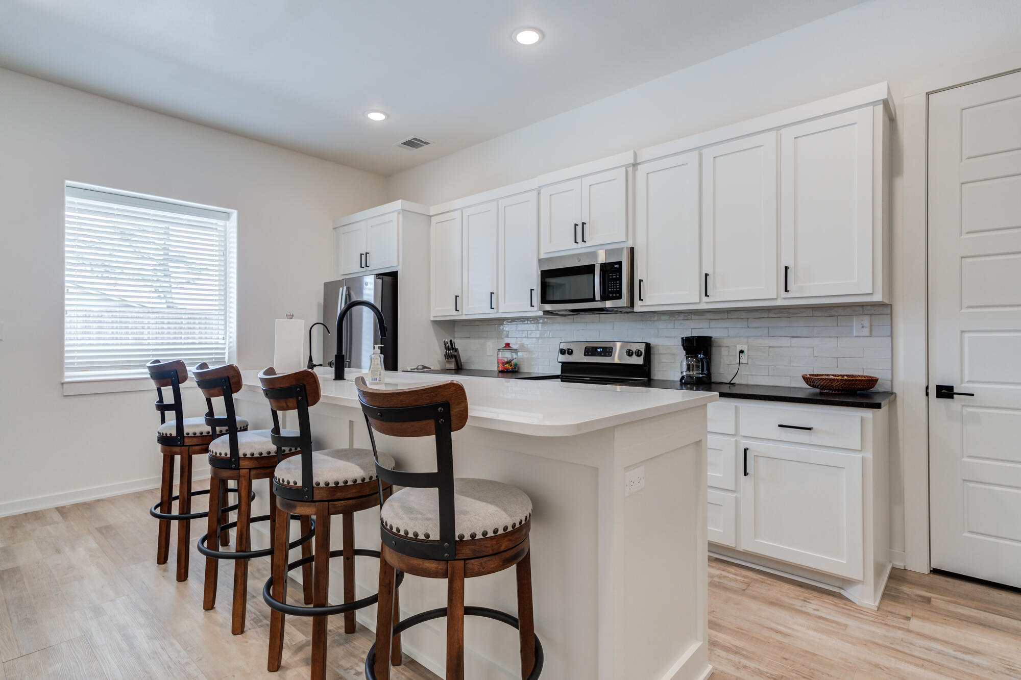 3405 107th Street Lubbock, TX 79423 - Photo 36 of 41 a kitchen with a dining table chairs and cabinets