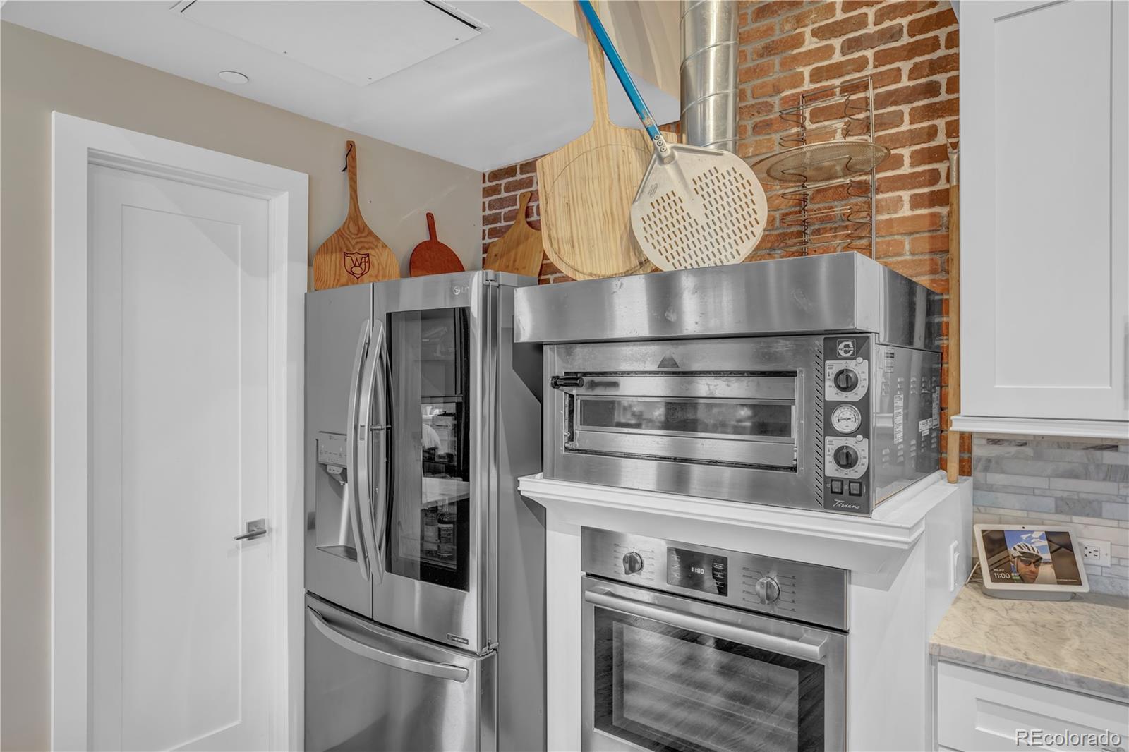 1501 Wazee Street, Unit 4B Denver, CO 80202 - Photo 12 of 40 a kitchen with stainless steel appliances granite countertop a stove and a refrigerator