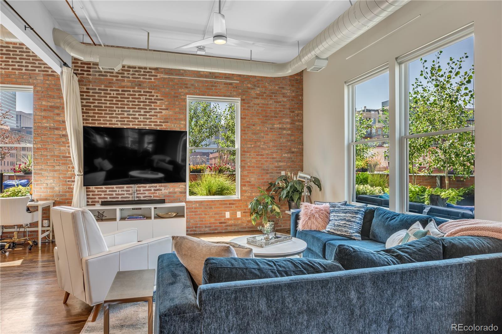 1501 Wazee Street, Unit 4B Denver, CO 80202 - Photo 13 of 40 a living room with furniture and a flat screen tv