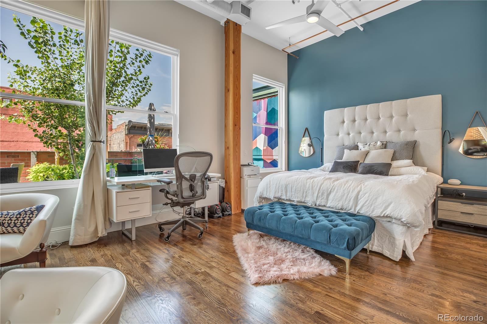 1501 Wazee Street, Unit 4B Denver, CO 80202 - Photo 16 of 40 a bedroom with a bed a table and chair with wooden floor