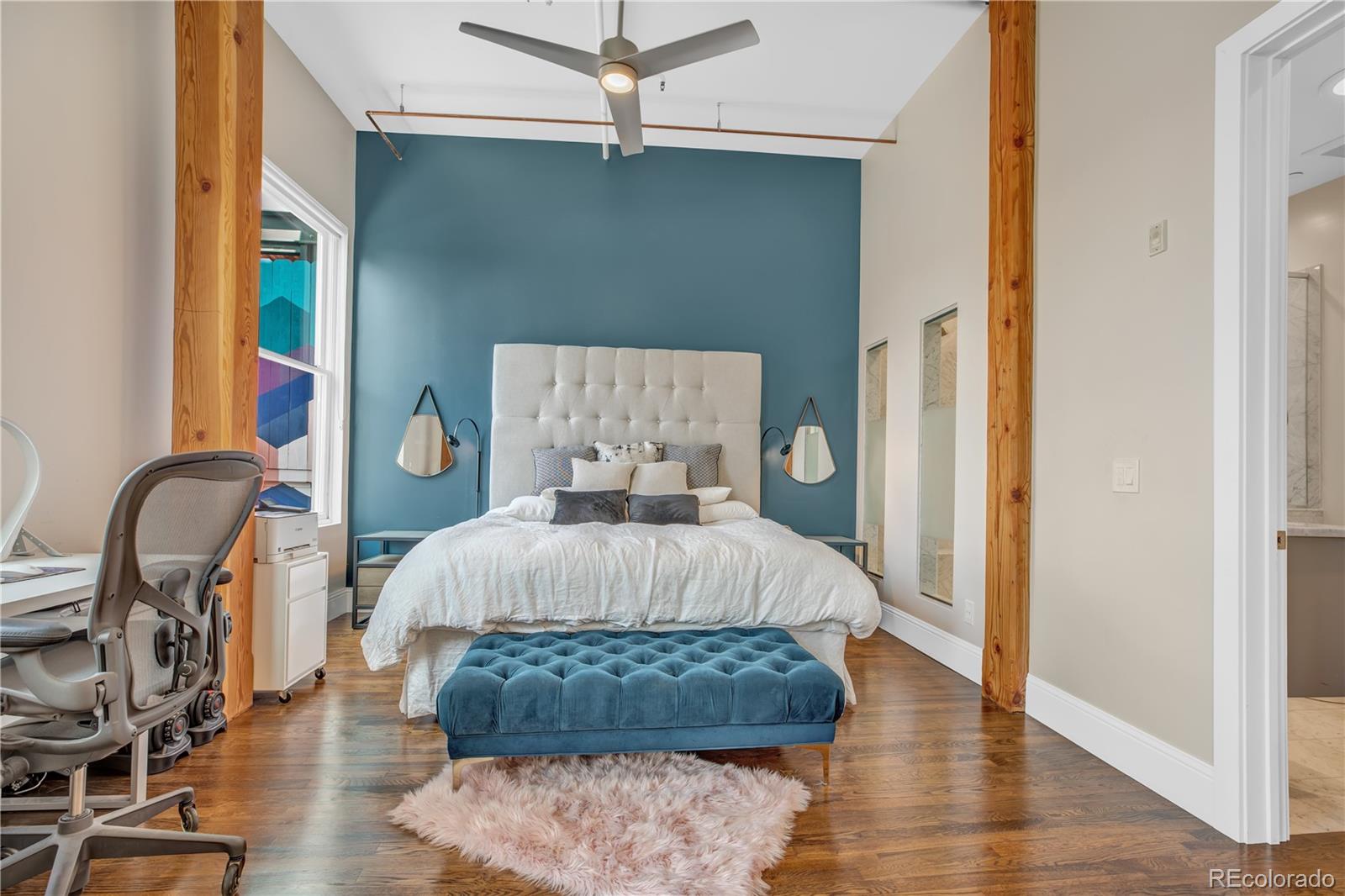 1501 Wazee Street, Unit 4B Denver, CO 80202 - Photo 17 of 40 a bed sitting in a bedroom next to a window with wooden floor