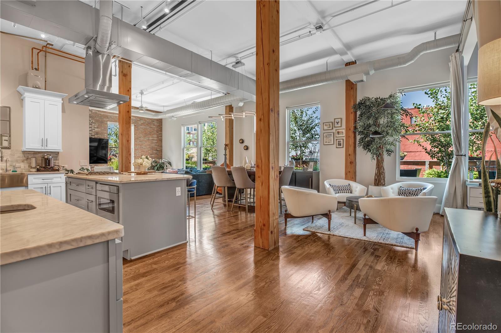 1501 Wazee Street, Unit 4B Denver, CO 80202 - Photo 3 of 40 a living room with couches a coffee table and chairs with wooden floor
