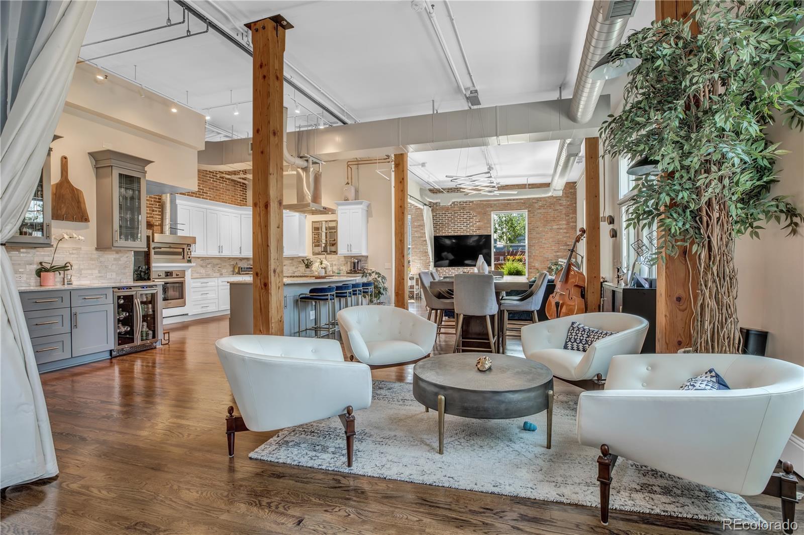 1501 Wazee Street, Unit 4B Denver, CO 80202 - Photo 4 of 40 a view of a dining room with furniture window and wooden floor