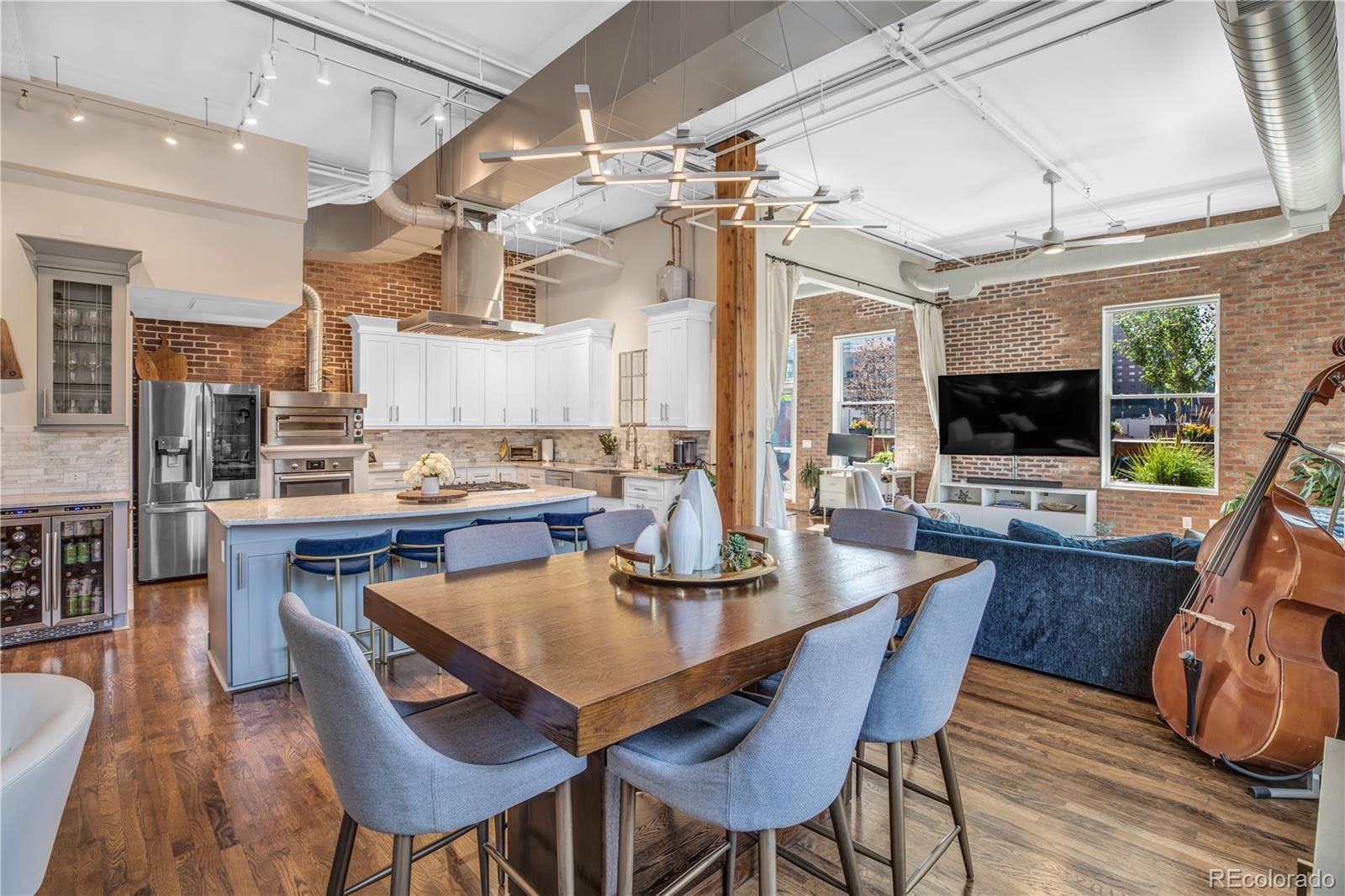 1501 Wazee Street, Unit 4B Denver, CO 80202 - Photo 7 of 40 a view of a dining room with furniture wooden floor and chandelier
