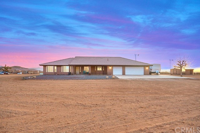 a front view of a house with a yard and lake view