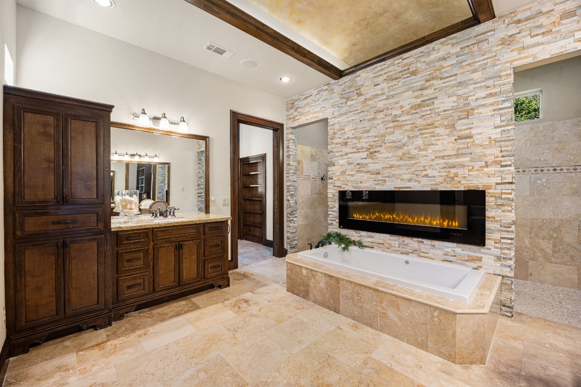27302 Keystone Bend Court Spring, TX 77386 - Photo 22 of 50 Primary bathroom offers double sinks, vanity area, sunken tub, electric fireplace and huge walk in shower.
