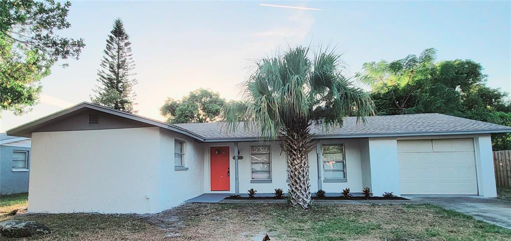 9235 St Regis Lane Port Richey, FL 34668 - Photo 1 of 1 a front view of a house with garden