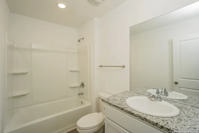 a view of backyard of house with wooden fence