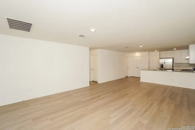 a view of kitchen with a sink and a refrigerator