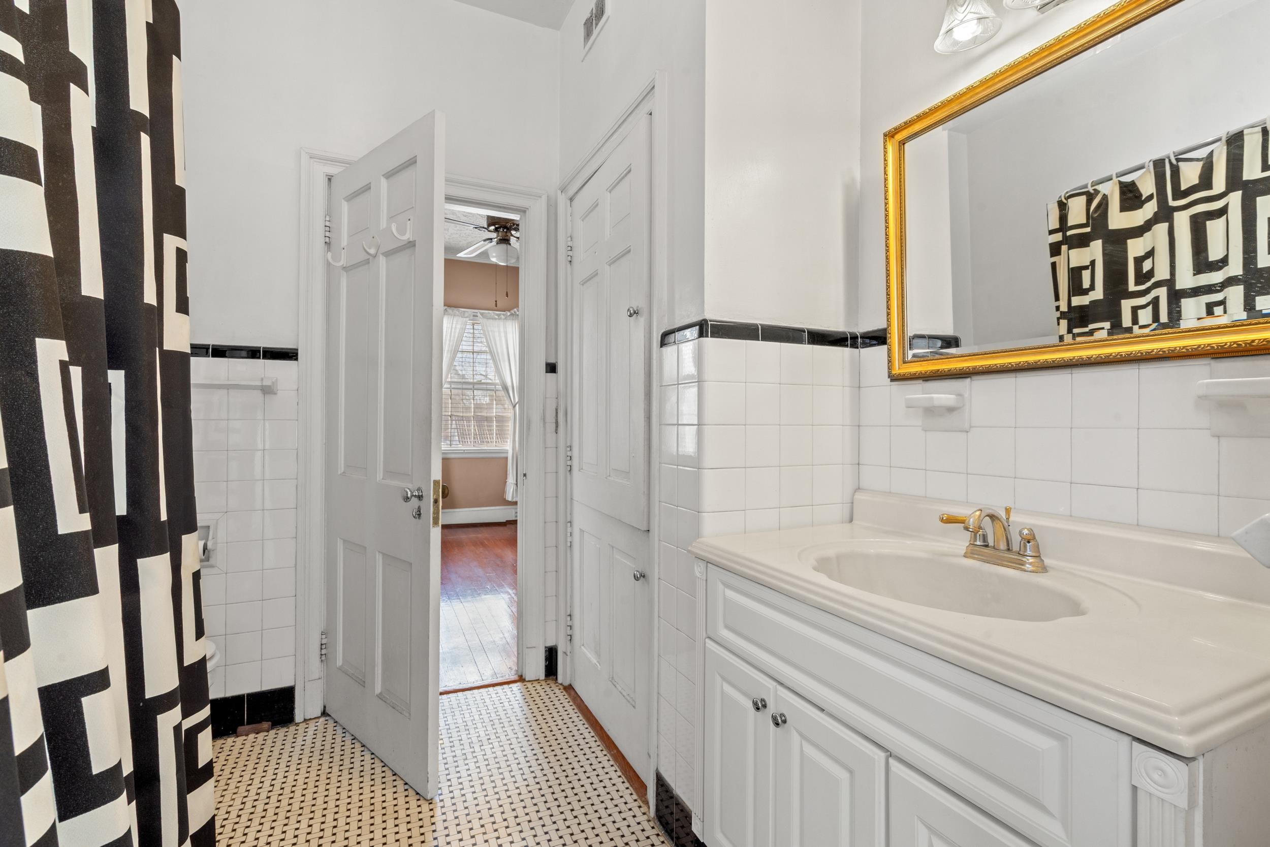 426 North Park Street Mullins, SC 29574 - Photo 19 of 39 Bathroom with vanity, tile walls, wainscoting, and a ceiling fan
