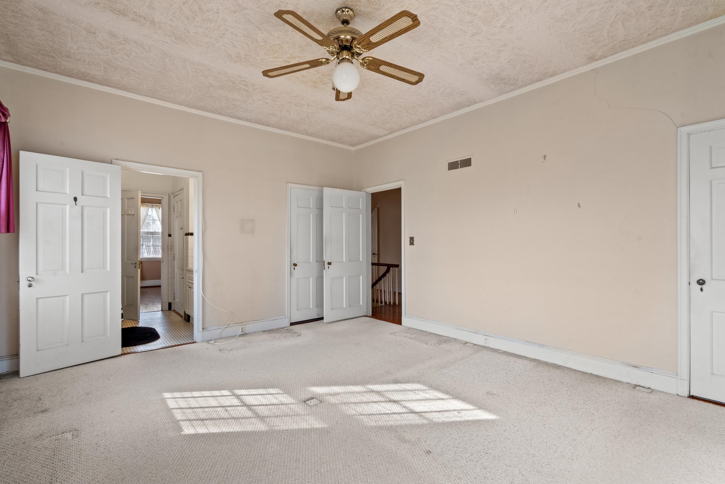 426 North Park Street Mullins, SC 29574 - Photo 21 of 39 Unfurnished bedroom featuring carpet, ornamental molding, a textured ceiling, and a ceiling fan