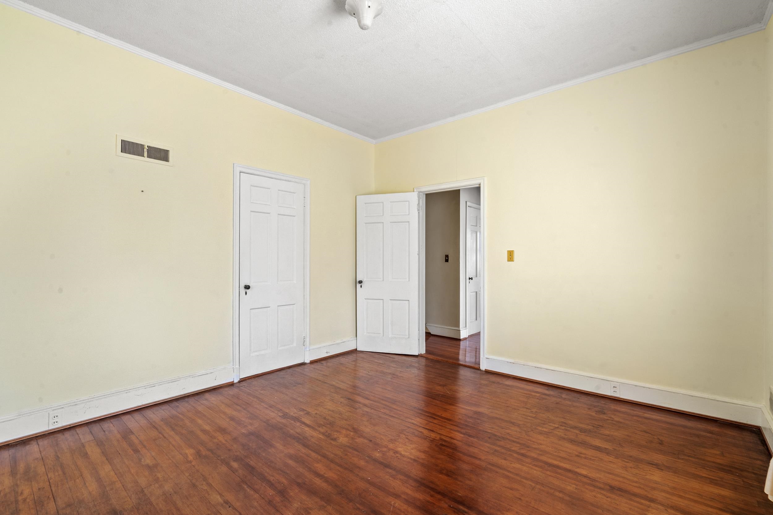426 North Park Street Mullins, SC 29574 - Photo 22 of 39 Unfurnished bedroom featuring ornamental molding and dark wood-type flooring