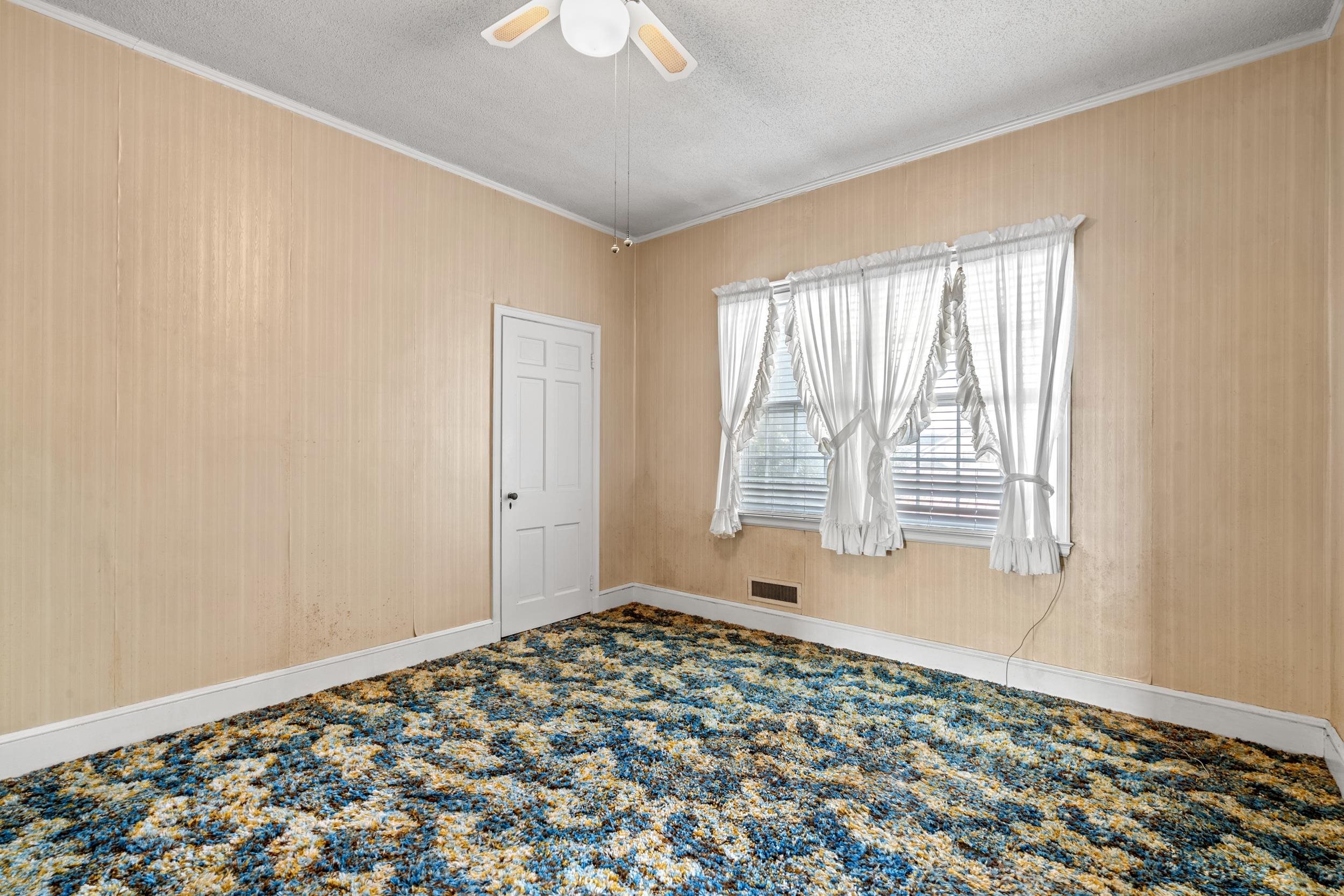 426 North Park Street Mullins, SC 29574 - Photo 25 of 39 Carpeted empty room featuring a textured ceiling, ornamental molding, and ceiling fan
