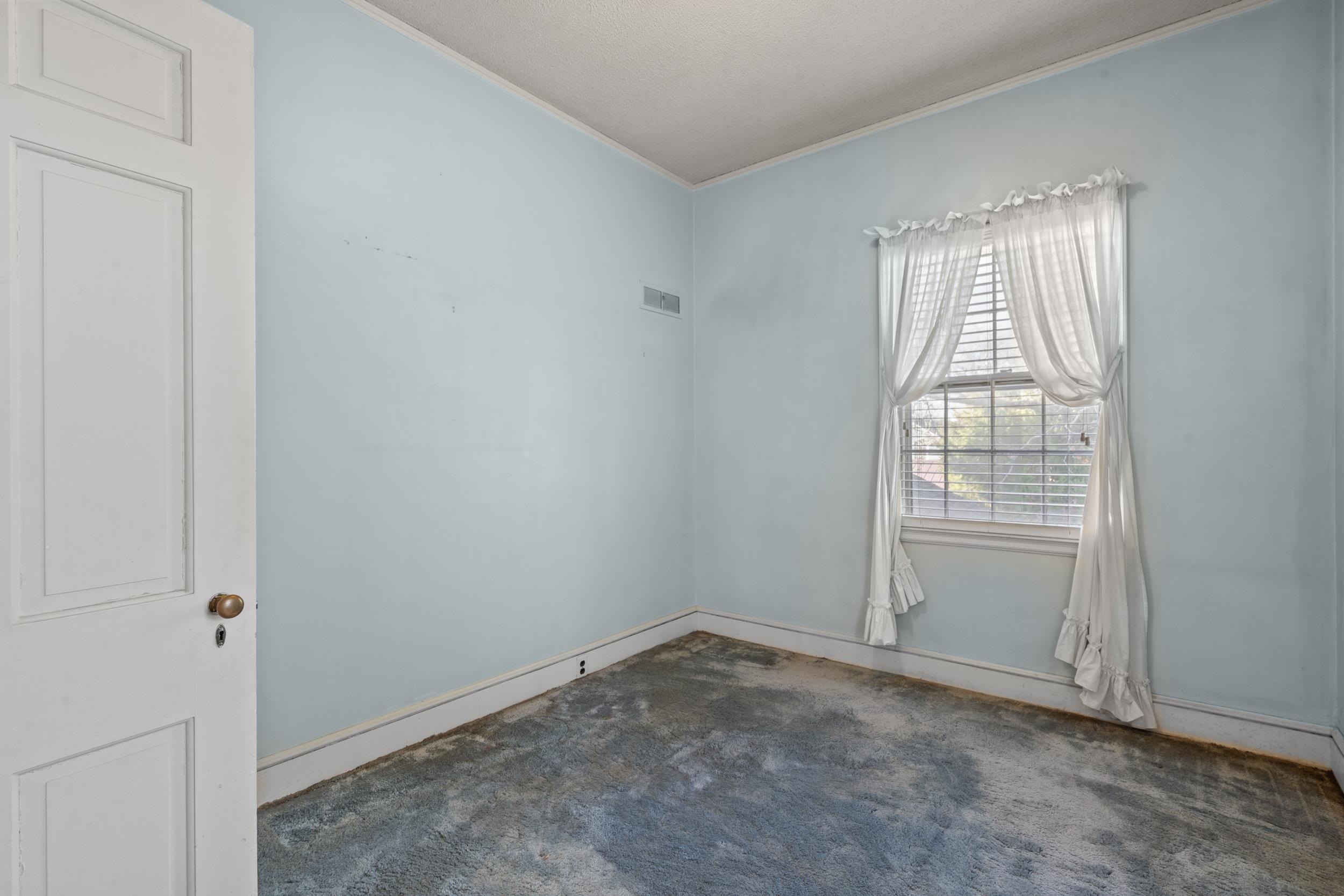 426 North Park Street Mullins, SC 29574 - Photo 27 of 39 Empty room with crown molding and dark carpet