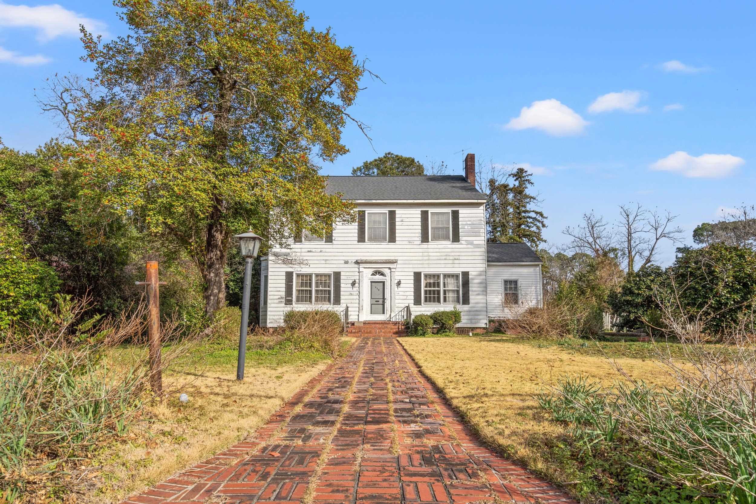 426 North Park Street Mullins, SC 29574 - Photo 31 of 39 Colonial house featuring a chimney and a front lawn