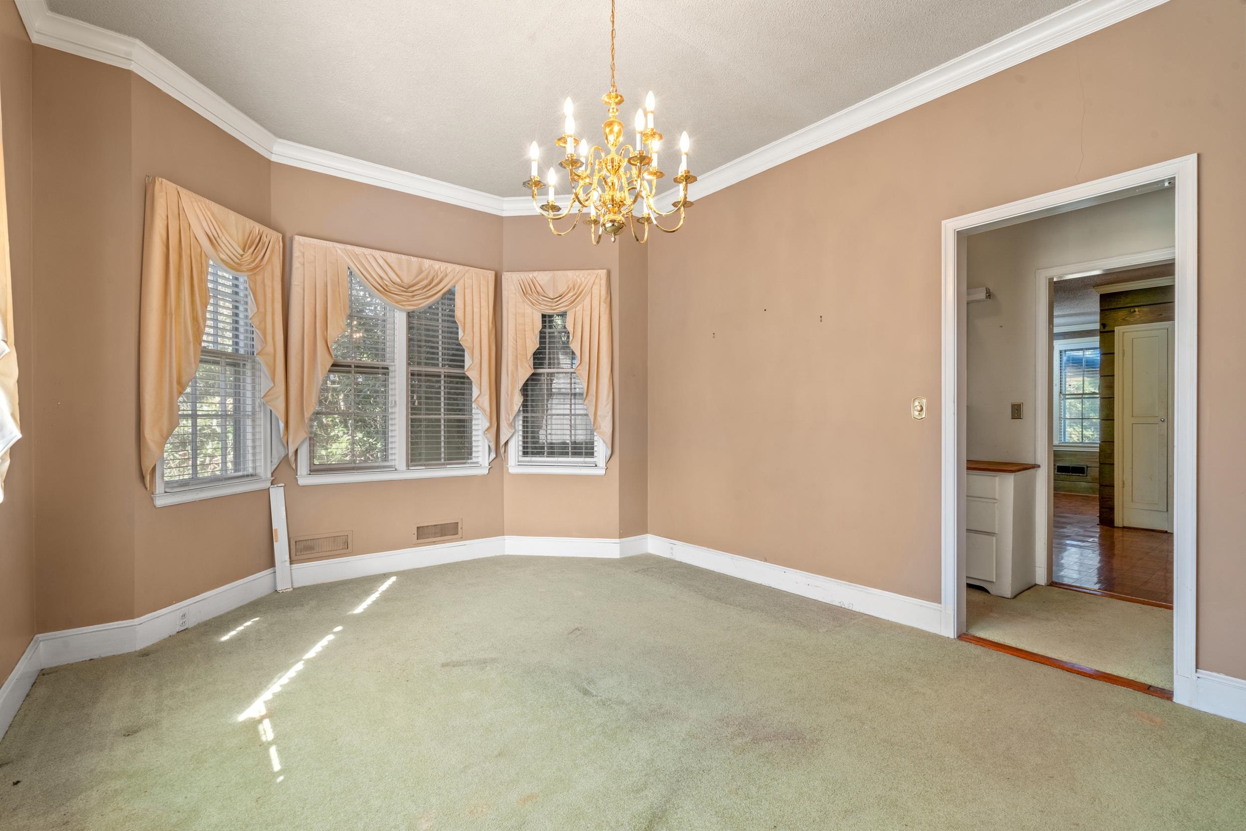 426 North Park Street Mullins, SC 29574 - Photo 5 of 39 Carpeted spare room featuring a chandelier and ornamental molding
