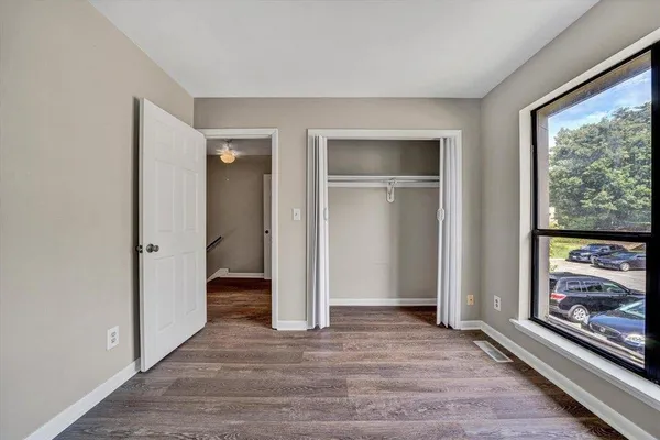 a room with a white walls and a mirror