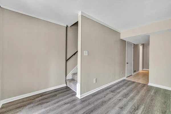 a view of a room with wooden floor