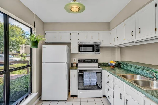 a kitchen with stainless steel appliances granite countertop a refrigerator sink and cabinets