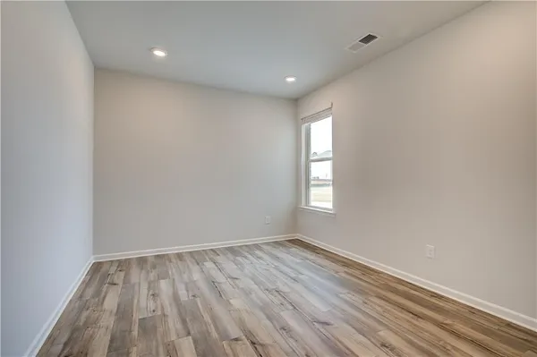 a view of room with window and wooden floor