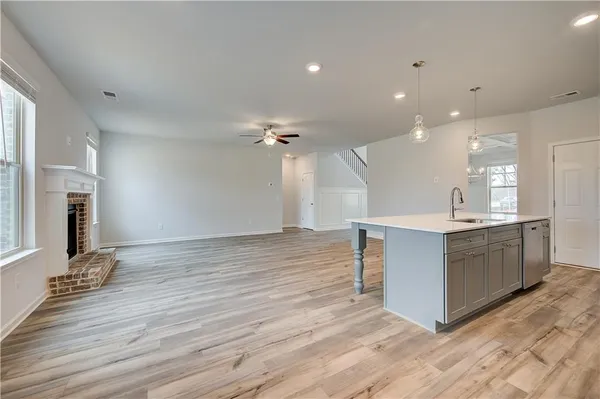 a view of kitchen with granite countertop cabinets and wooden floor
