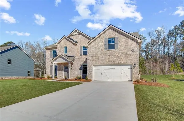 a front view of a house with a yard and garage
