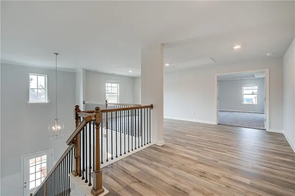 a view of a hallway view with wooden floor and staircase