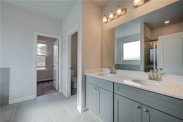 a bathroom with a sink double vanity and a mirror