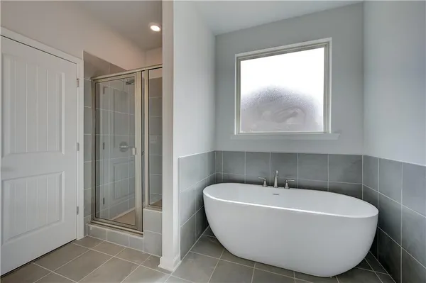 a bathroom with a bathtub and shower
