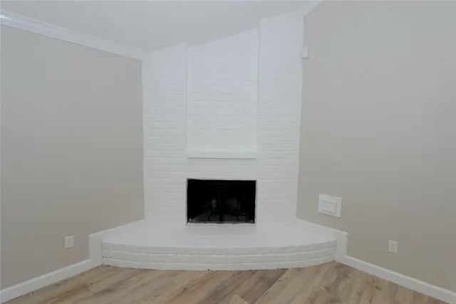 a living room with a fireplace and a wooden floor