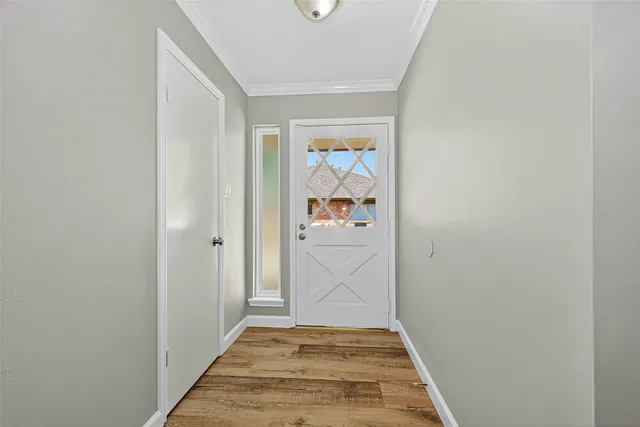 a view of hallway with wooden floor