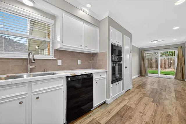 a kitchen with granite countertop a stove and a sink