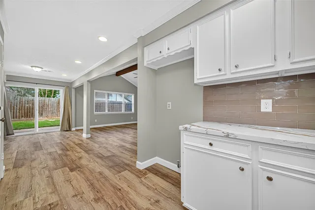 a view of an empty room with a kitchen