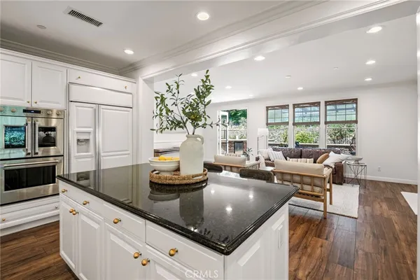 a kitchen with a sink appliances and cabinets