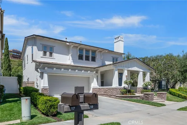 a front view of a house with potted plants