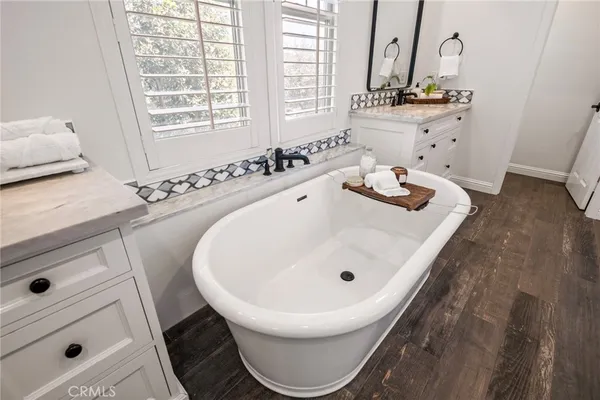 a workspace with wooden floor and a window