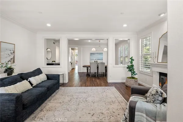 a living room with furniture fireplace and a large window