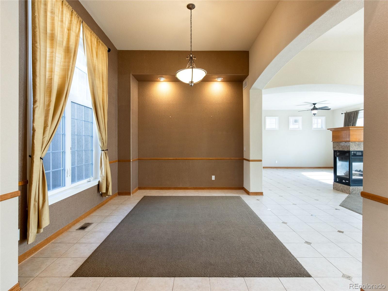 4940 West 107th Loop Westminster, CO 80031 - Photo 11 of 44 a view of empty room with wooden floor and fan